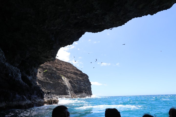 Honopu sea cave with a waterfall in the background