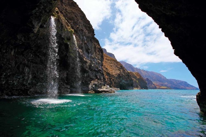 Waterfalls pouring off the Na Pali Coast Cliffs
