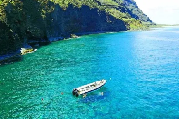 People snorkeling off a Private Charter on the Na Pali Coast of Kauai.