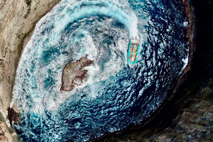 a boat in open ceiling cave