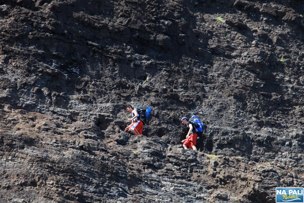 a group of people on a rocky hill