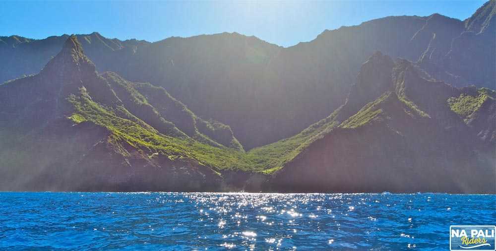 a large body of water with a mountain in the background