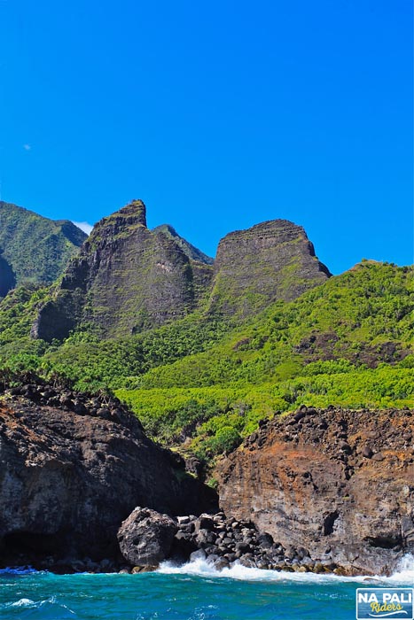 a rocky mountain with trees in the background