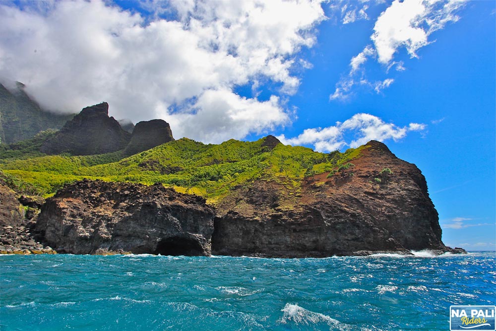 a large body of water with a mountain in the background