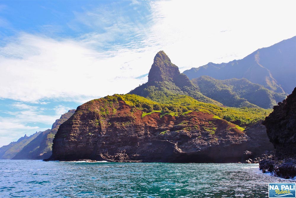 a large body of water with a mountain in the background