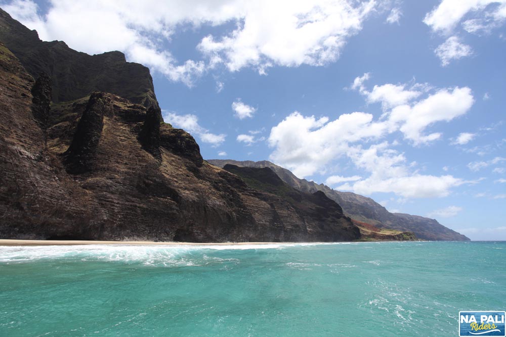 a body of water with a mountain in the background
