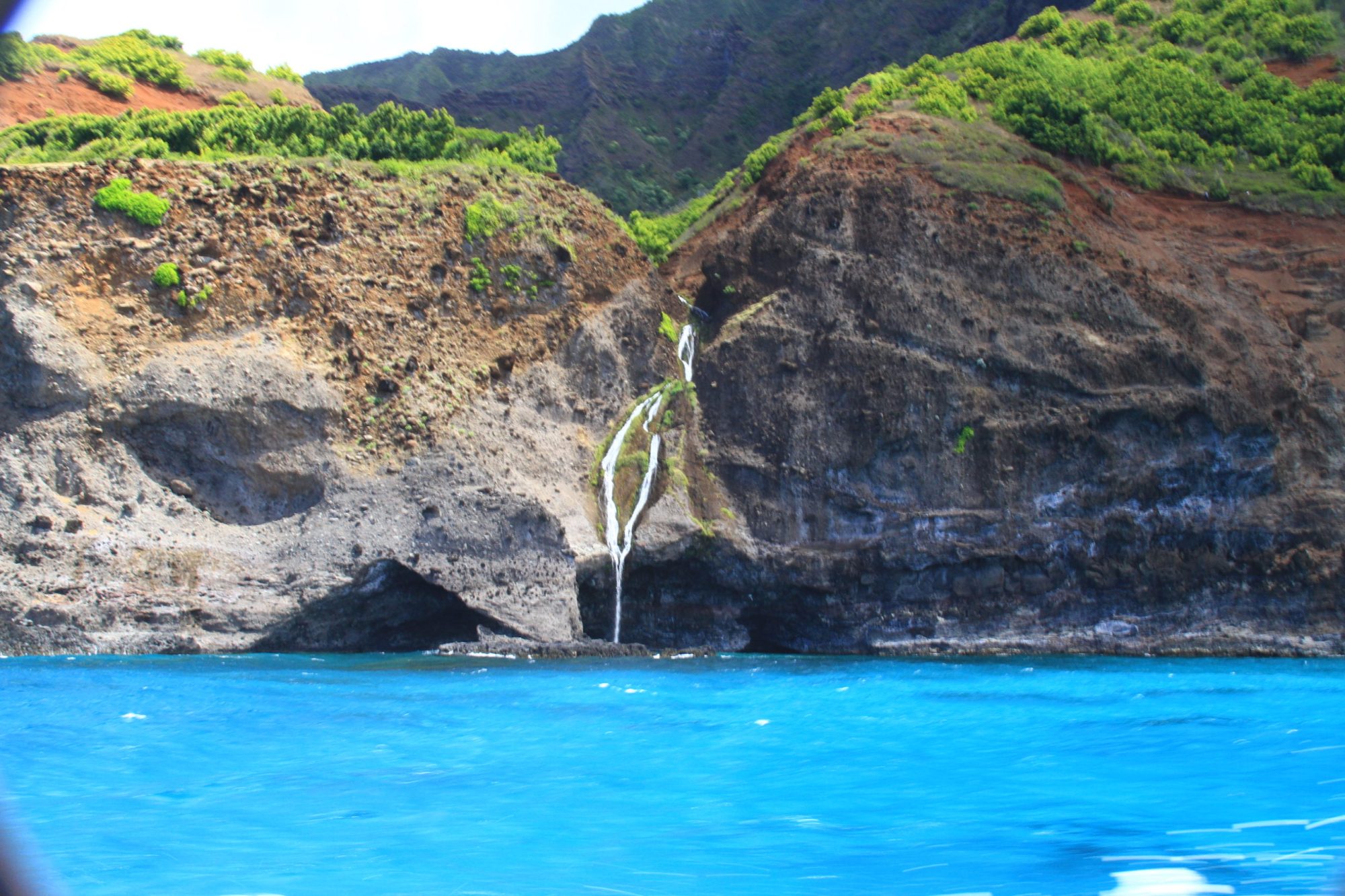Hanakoa Waterfall Next To a Na Pali Coast Sea Arch Hanakoa Waterfall Next To a Na Pali Coast Sea Arch