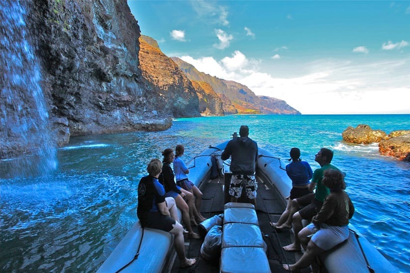 A Group of people on a Na Pali Coast Raft Tour of the Na Pali Coast A Group of people on a Na Pali Coast Raft Tour of the Na Pali Coast