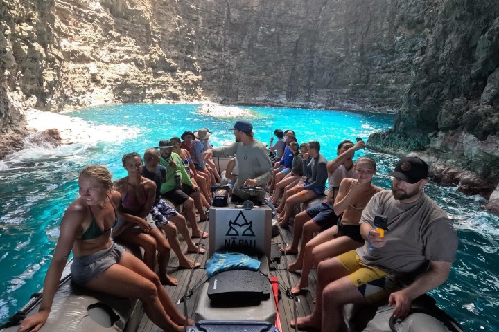 a group of people sitting on top of a mountain