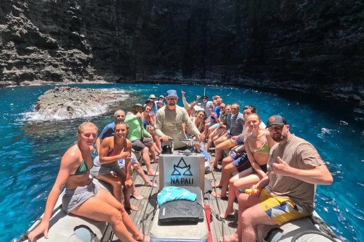 a group of people riding on the back of a boat