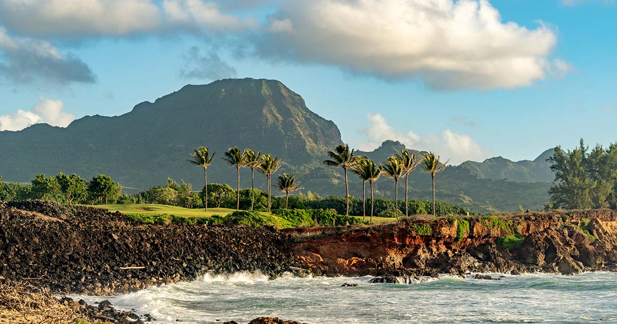 haupu-the-legendary-giant-guardian-of-kauai Hāʻupu Mountain on Kauai’s southern coast, a legendary giant guardian in Hawaiian culture with lush ridges and dramatic cliffs overlooking the sea